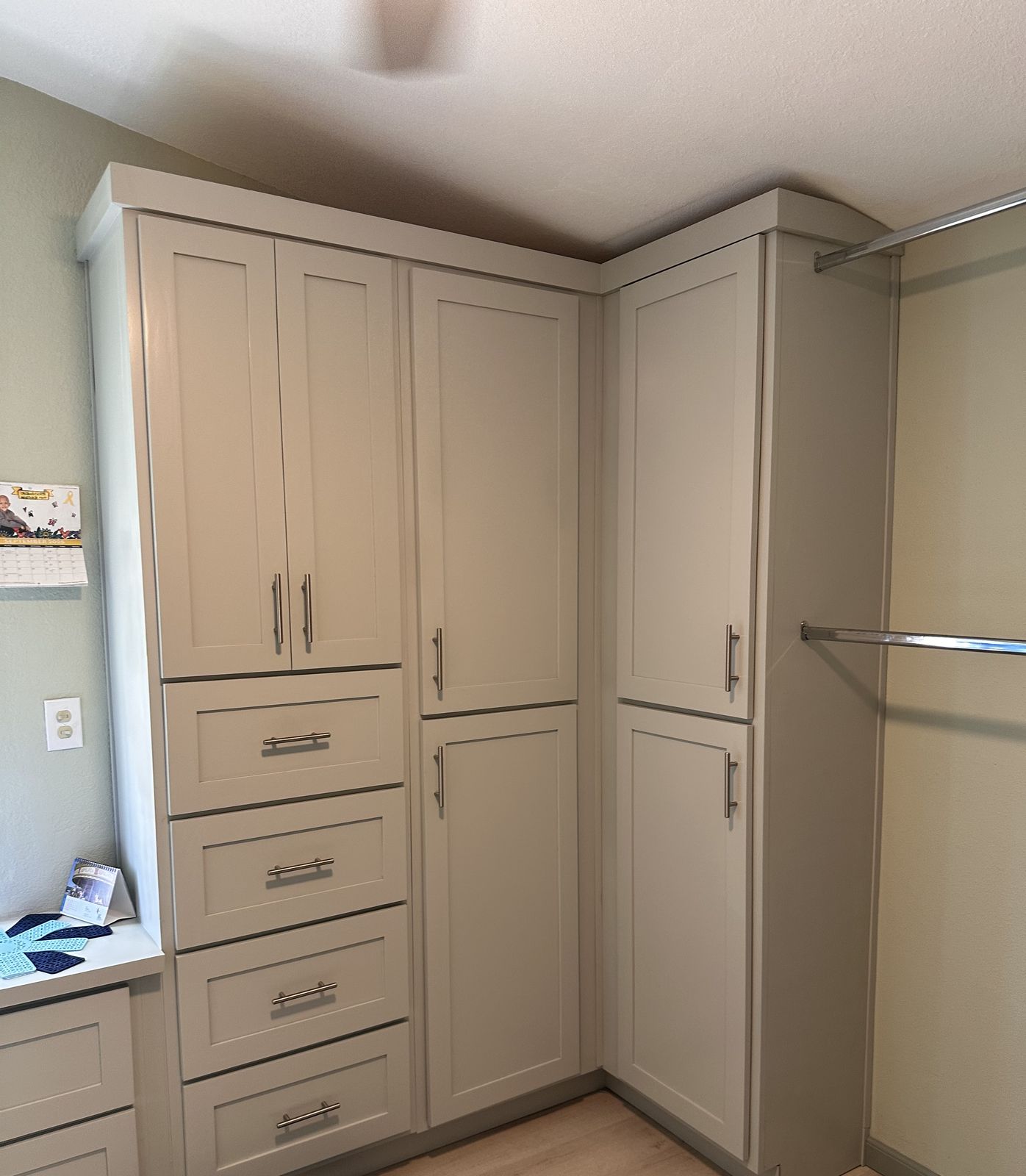 Gray walk-in closet wardrobe cabinets with drawers and hanging rods