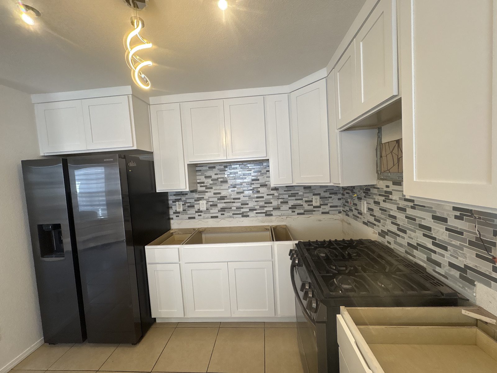 White shaker kitchen with mosaic tile backsplash